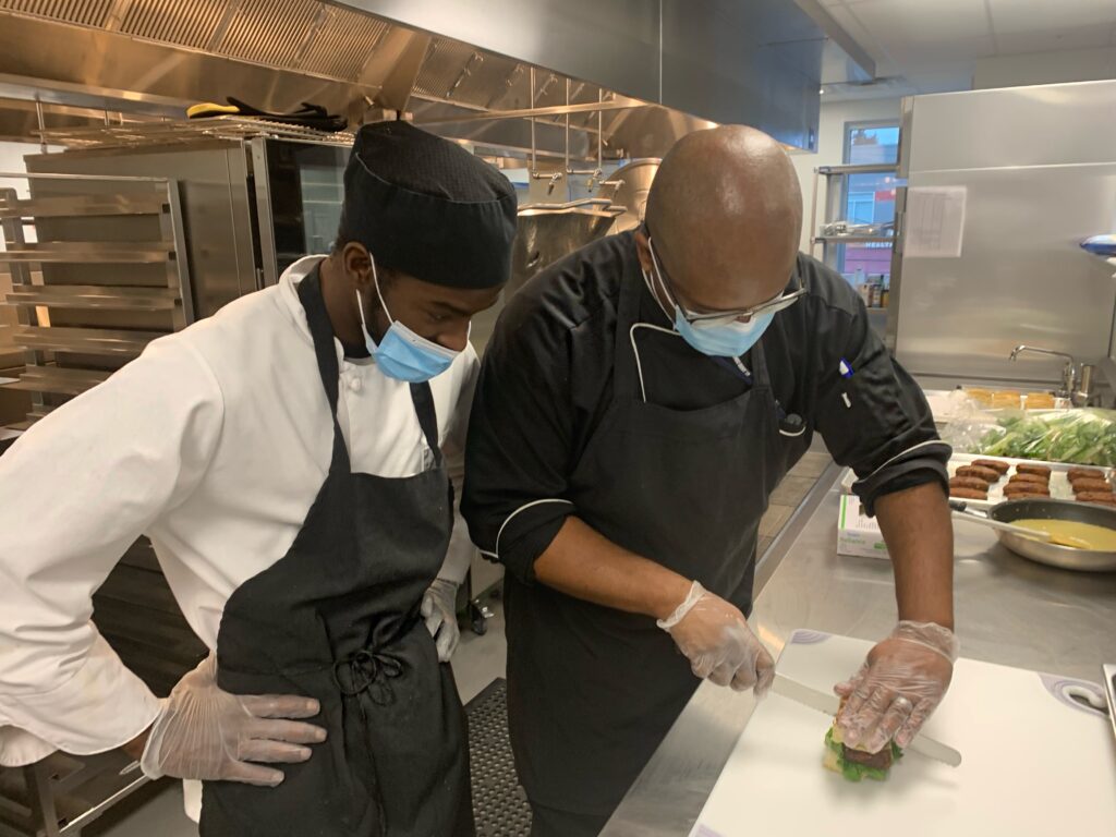 Chef showing culinary student proper knife skills