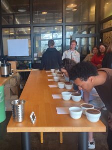 A student takes a whiff of coffee grounds 