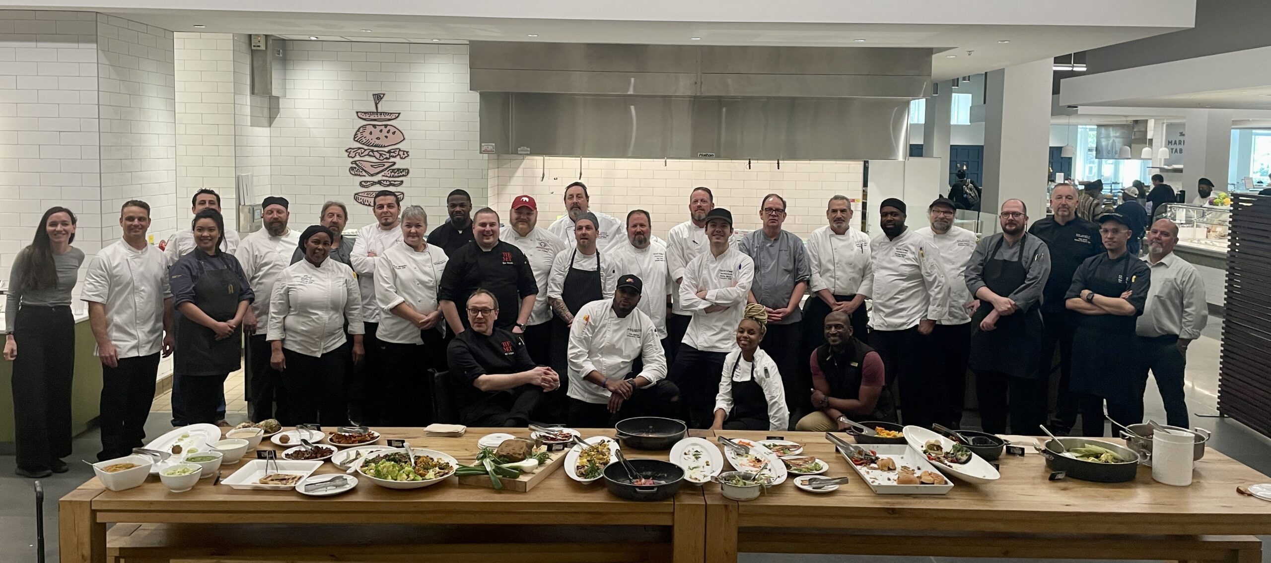 Participants in the Southeast Midwest Plant-Forward training at Emory University pose with their plant-based dishes