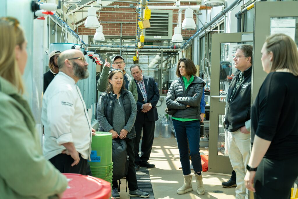 Attendees explore Roger Williams’ wet lab and shellfish hatchery. Photo Credit: Stacey Pacheo/Roger Williams University