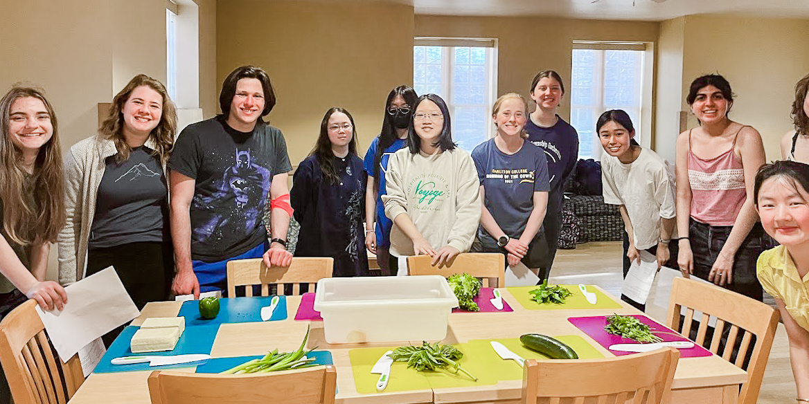 Members of Environmental Carls Organized (ECO) pose during their plant-based cooking demonstration, led by Fellow Elise Kulers 