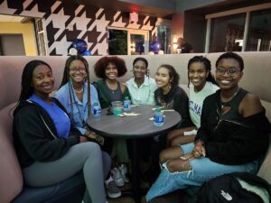 A group of students attends the cafe opening