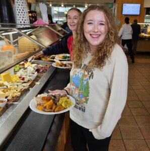 Students fill their plates with local food for a food service company's Eat Local Challenge.