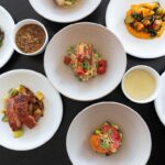 An overhead shot of composed dishes of food.