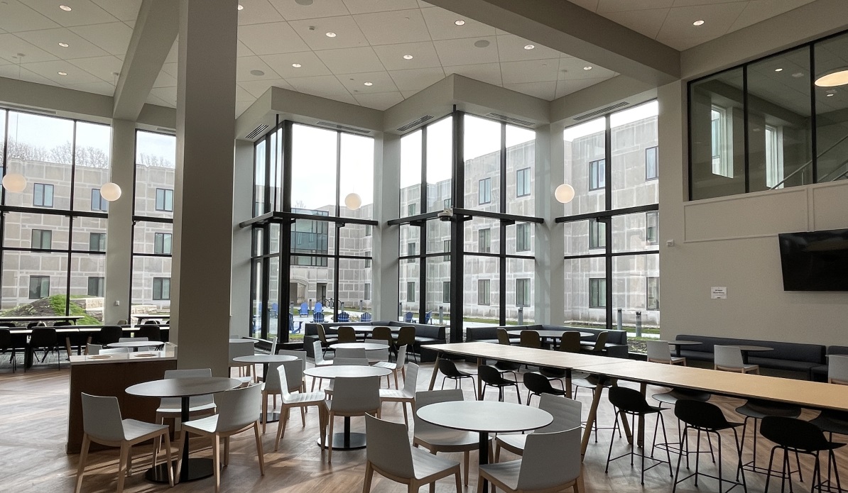 A dining and seating area with floor to ceiling windows.