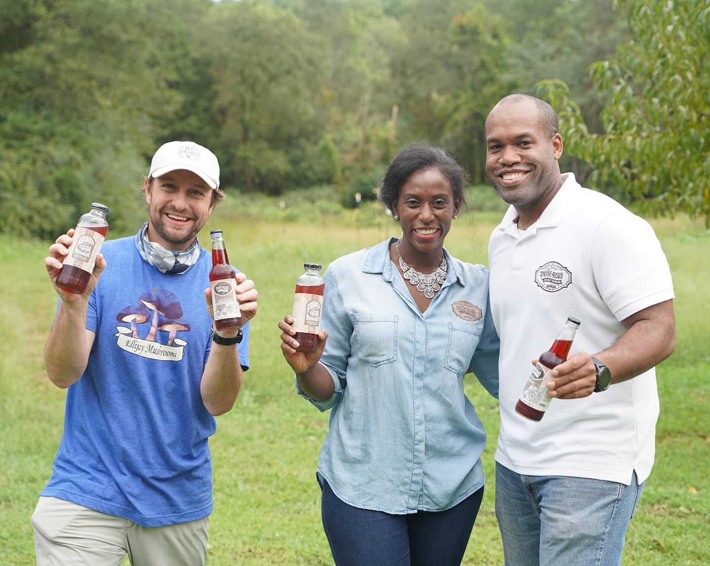 people holding smoothies from pop up market