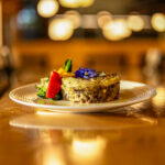 A glamour shot of a piece of shepherd's pie, piped potato on top of beans.