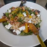 Plate of food with grains and carrots.