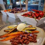 plate of beans and carrots with a scoop of labne on top.