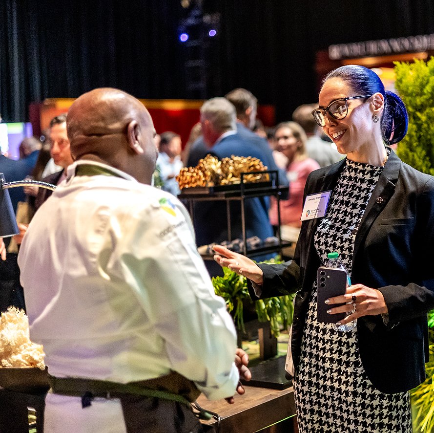 chef and woman interact at function