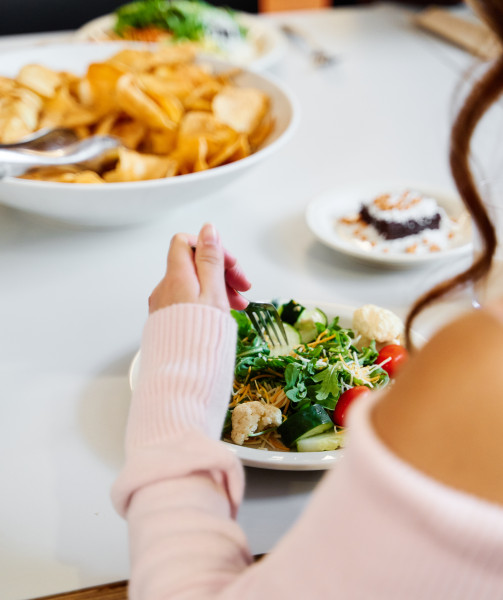 student eating salad