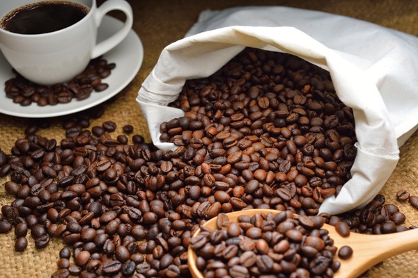 Coffee beans spilling out of a canvas bag