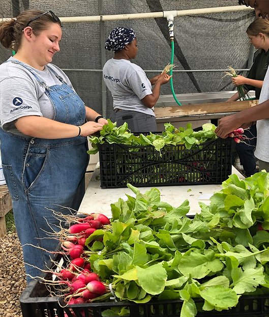 woman in overalls with produce