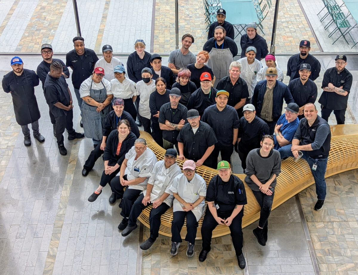 An overhead group shot of a workplace of culinary professionals.