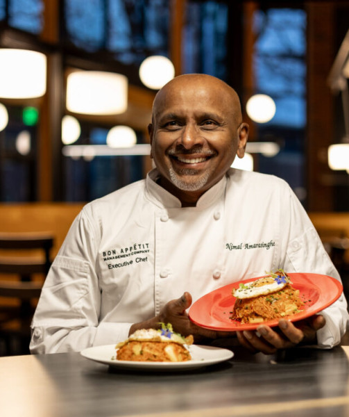 male chef seated showing food