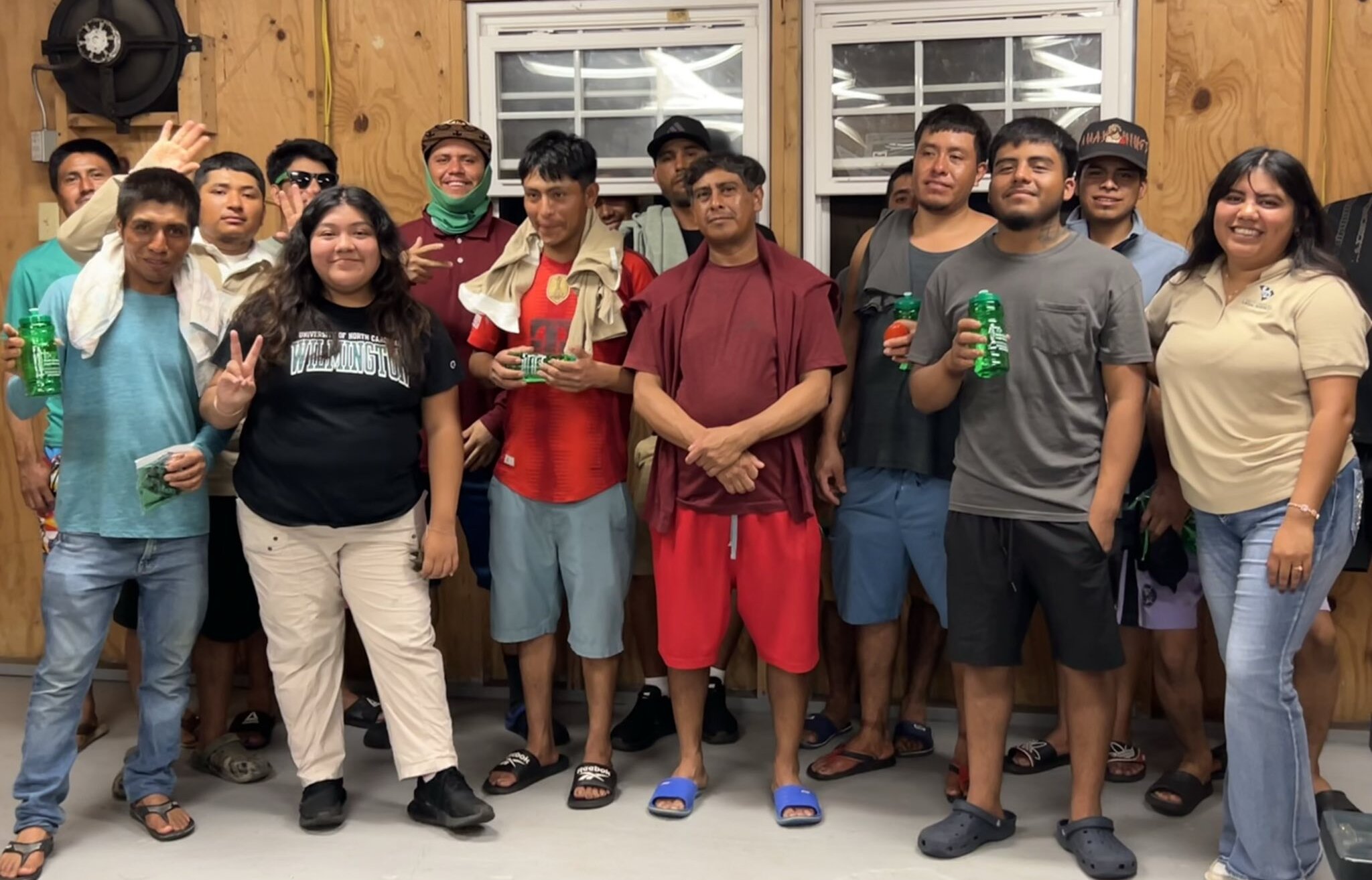 A group of farmworker advocates gathered in an office setting.