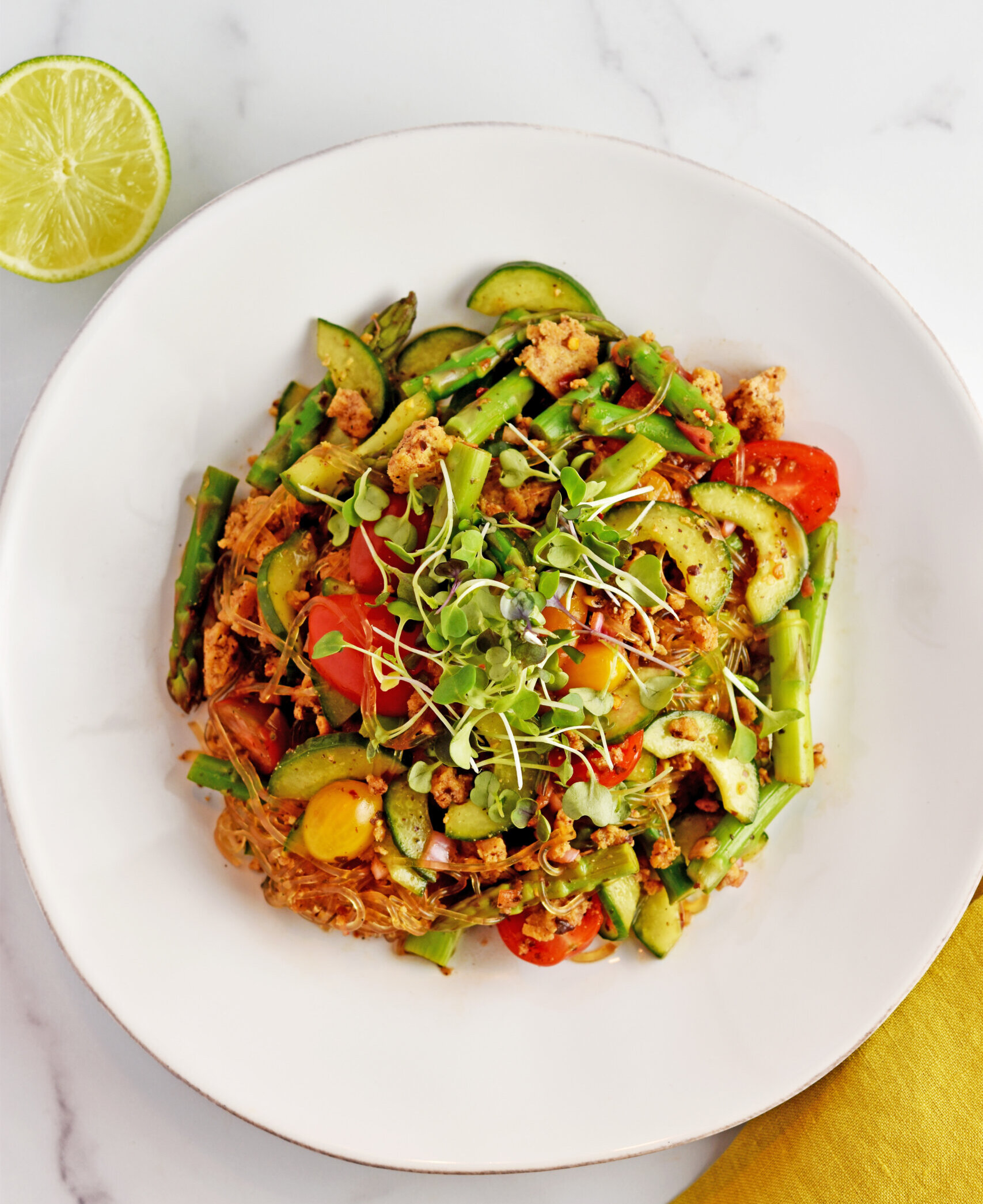 Overhead shot of a tamarind-kelp noodle salad in a white bowl frm the Queer Food Foundation