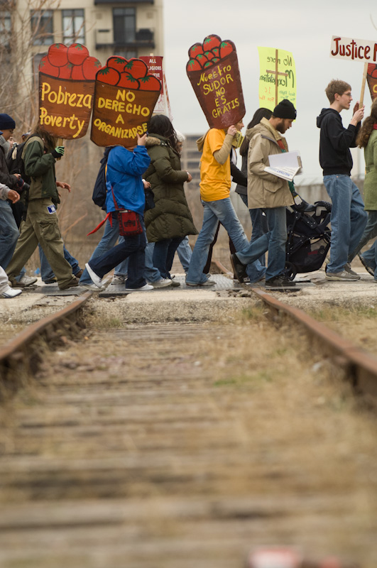 Marching across Chicago, workers are joined by their allies. Through extensive outreach, the Coalition has built a broad base of support in the student and faith populations, among other friends. The goal is to educate consumers to demand social accountability from the major corporations that they spend their money with. Photo by JJ Tiziou.