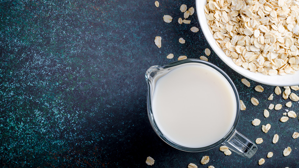 Oat milk in a glass pitcher 