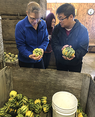 Front of House Supervisor Kitty Jones and Front of House Manager Brett Harvey checking out Mustard Seed Farms’ squash 