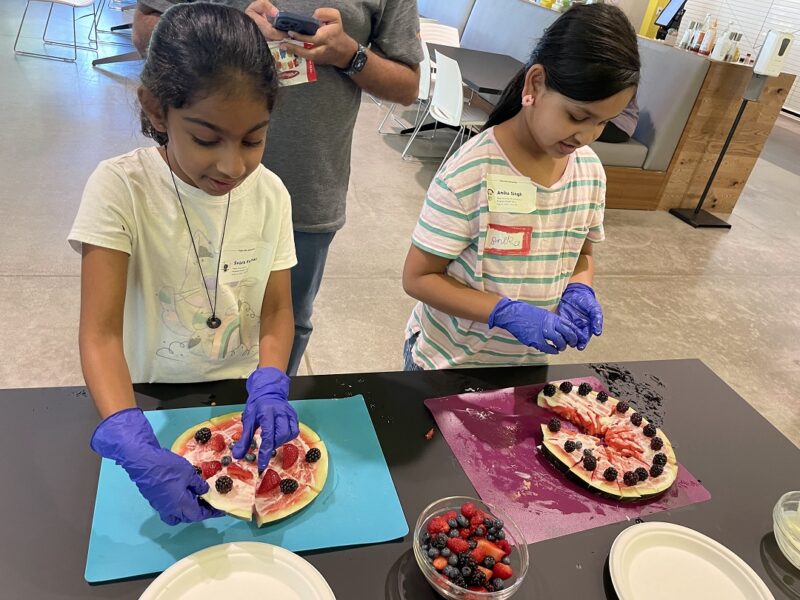 Kids make watermelon pizzas at a Bon Appetit food education event
